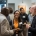 A group of business executives networking and socializing at a networking event, cheering with glasses of wine. Business professionals communicating at convention center.