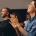 Business professionals applauding at a seminar.